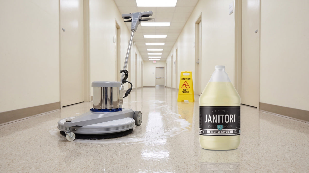 Floor machine cleaning a commercial linoleum corridor beside a JANITORI Floor Cleaner No.61 jug
