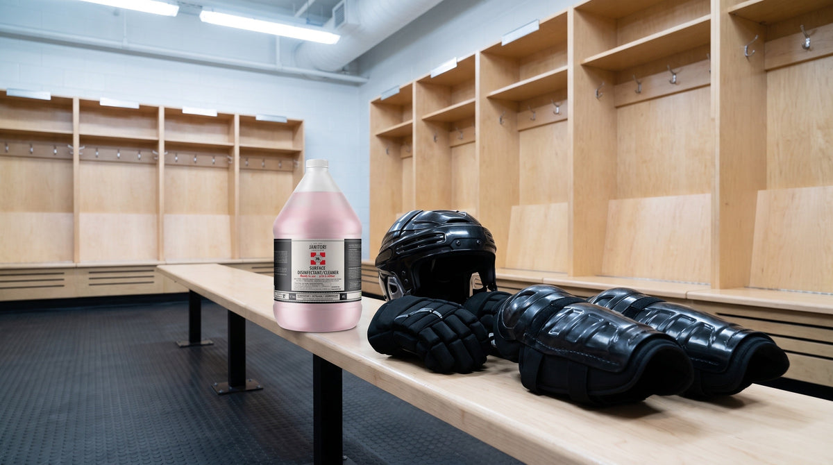 JANITORI surface disinfectant on a bench in an arena dressing room with hockey gear